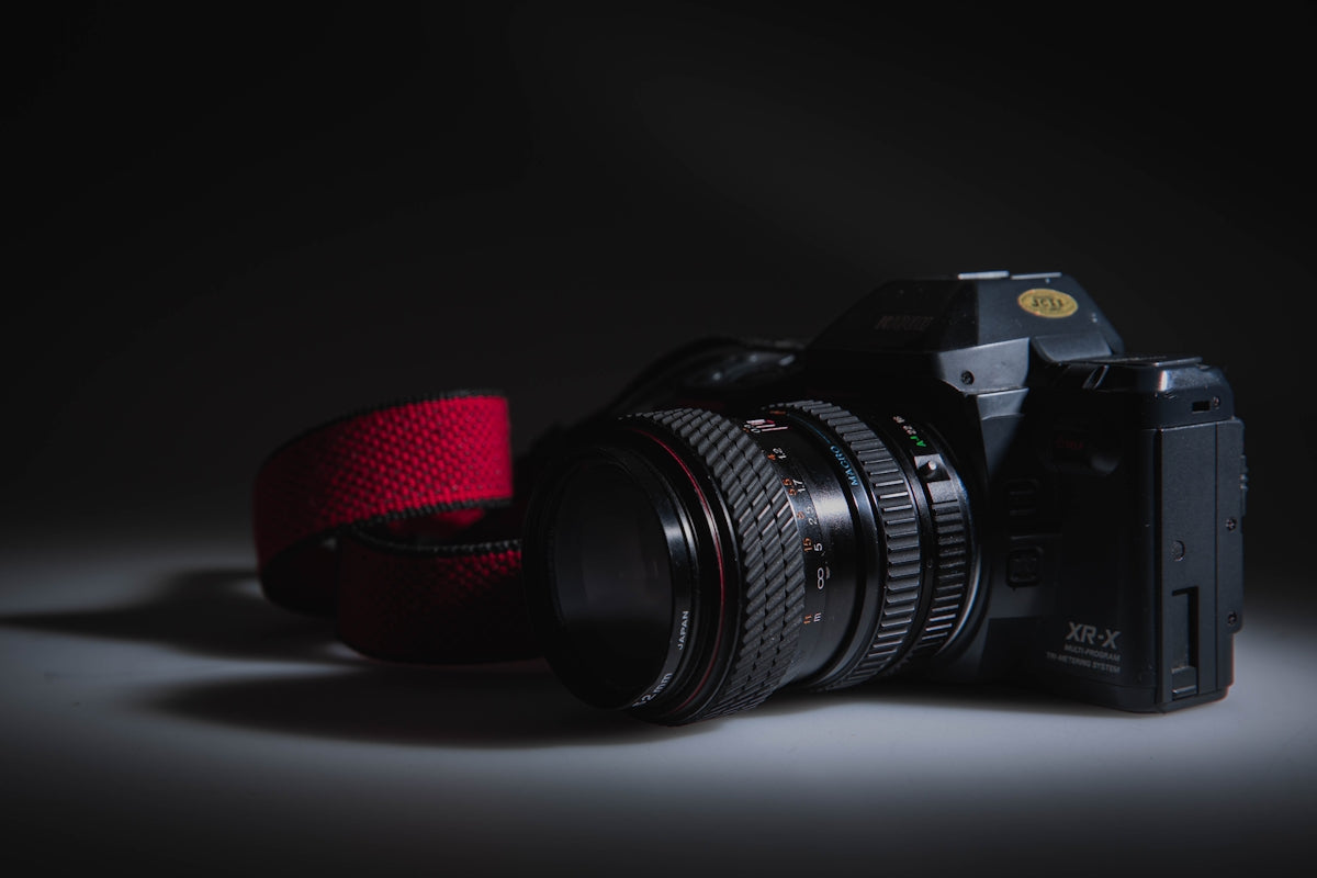 a camera with a red strap around it