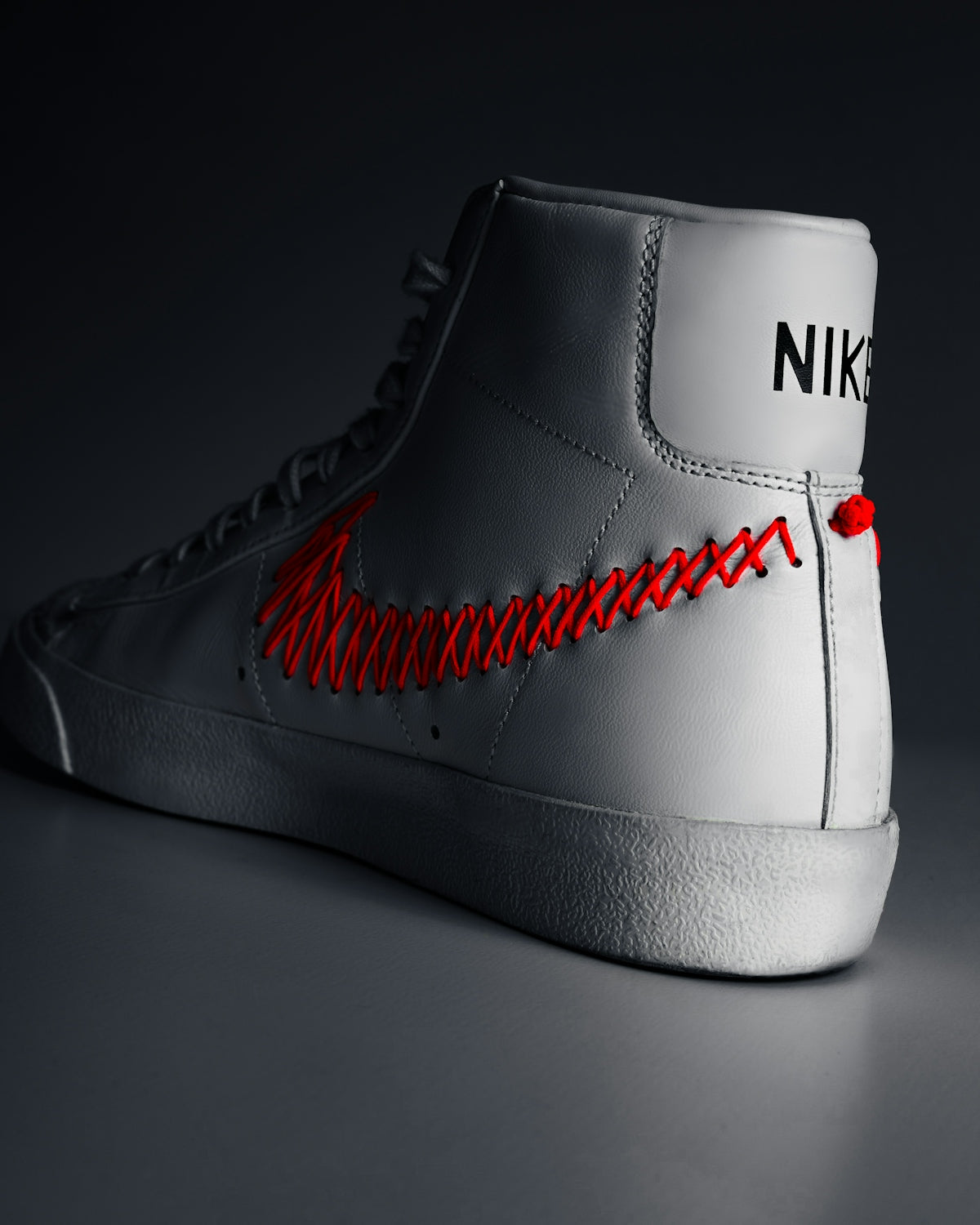 A pair of white sneakers with red laces
