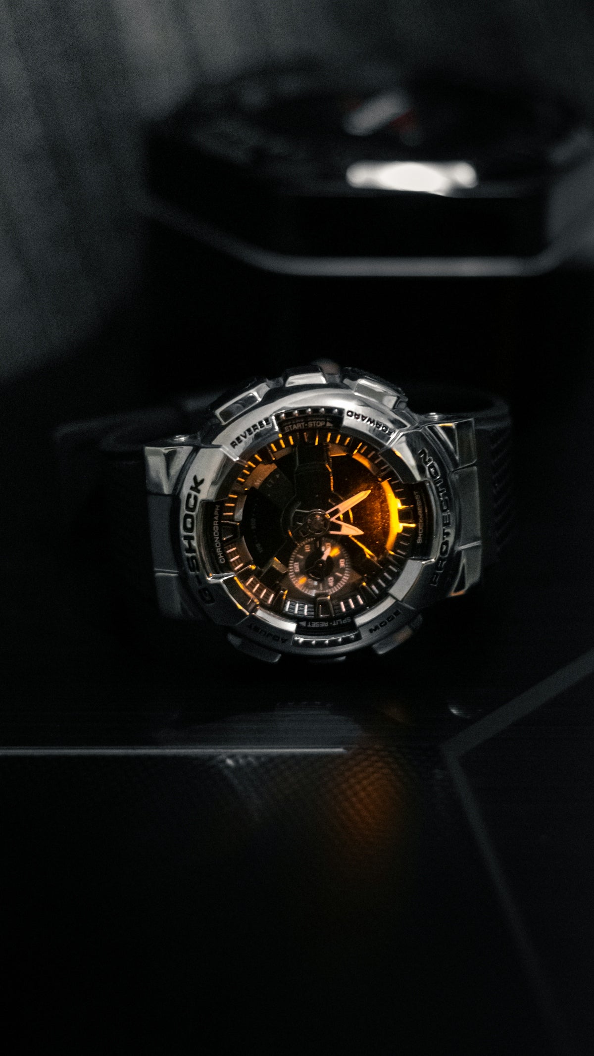 A watch sitting on top of a black table