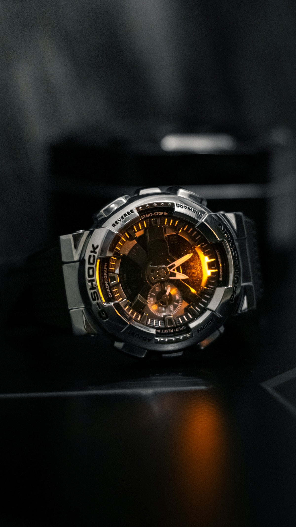 A watch sitting on top of a black table