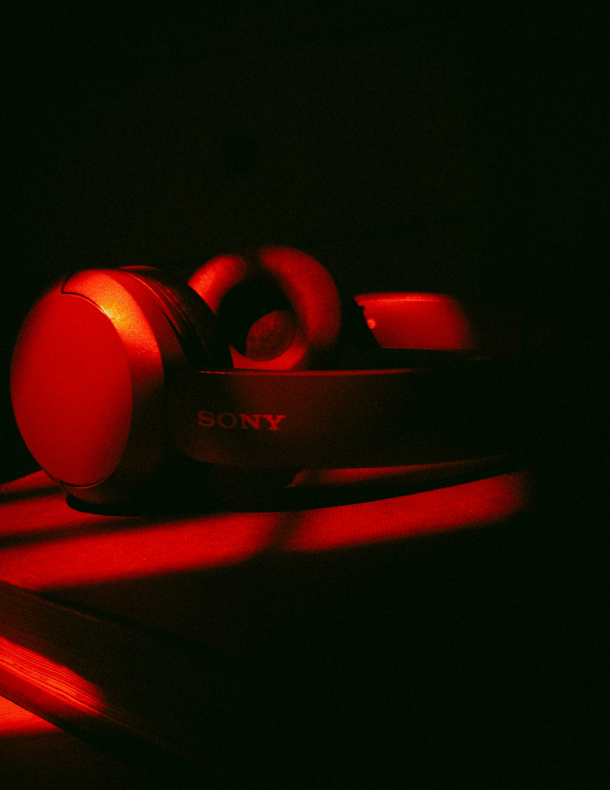 Sony headphones illuminated by red light