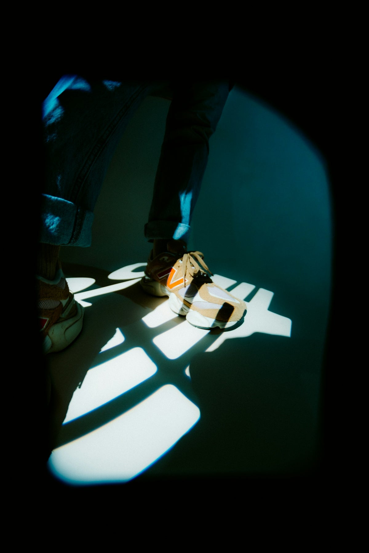 Person wearing sandals with light patterns on floor