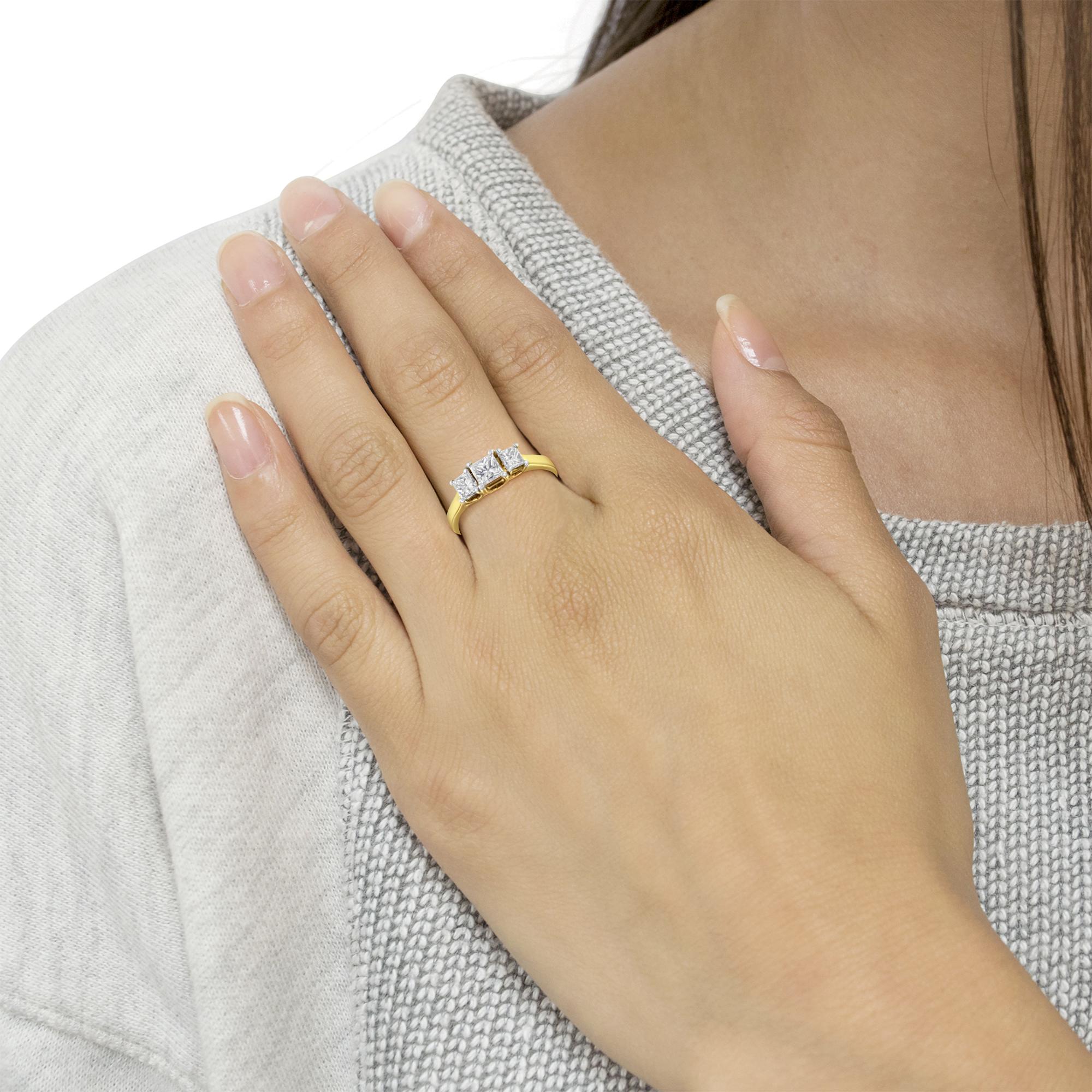 1 CTTW Princess Diamond Three Stone Band Ring on finger ∣ 10K Yellow Gold