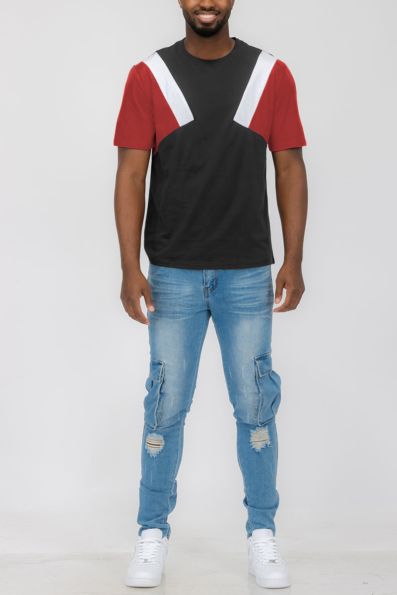 A red, white, and black ANGLED COLOR BLOCK TEE. Front of t shirt in full view worn by a male model.