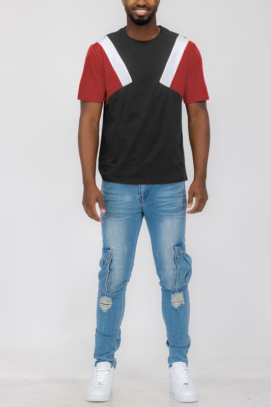 A red, white, and black ANGLED COLOR BLOCK TEE. Front of t shirt in full view worn by a male model.