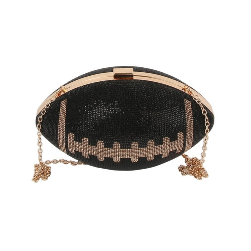 Black cross body bag shaped like a football with a gold toned chain and gold accents on a white background