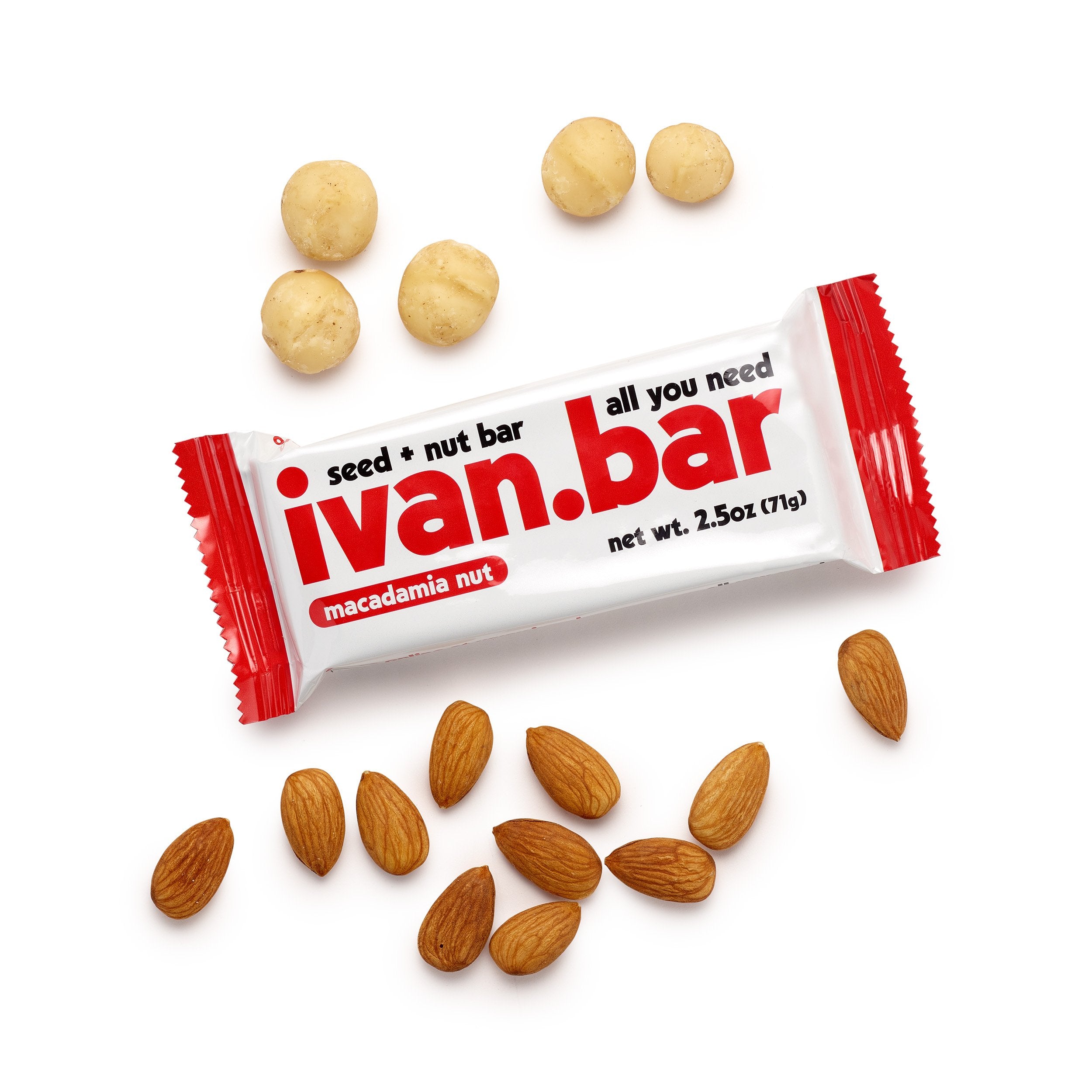 Close-up shot of the unwrapped ivan.bar, clearly showing whole almonds, pieces of macadamia nuts, and various seeds clustered together.