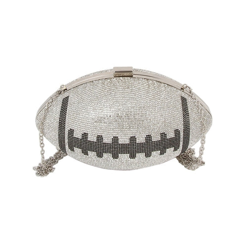 Silver colored football-shaped cross body bag with rhinestone details on a white background
