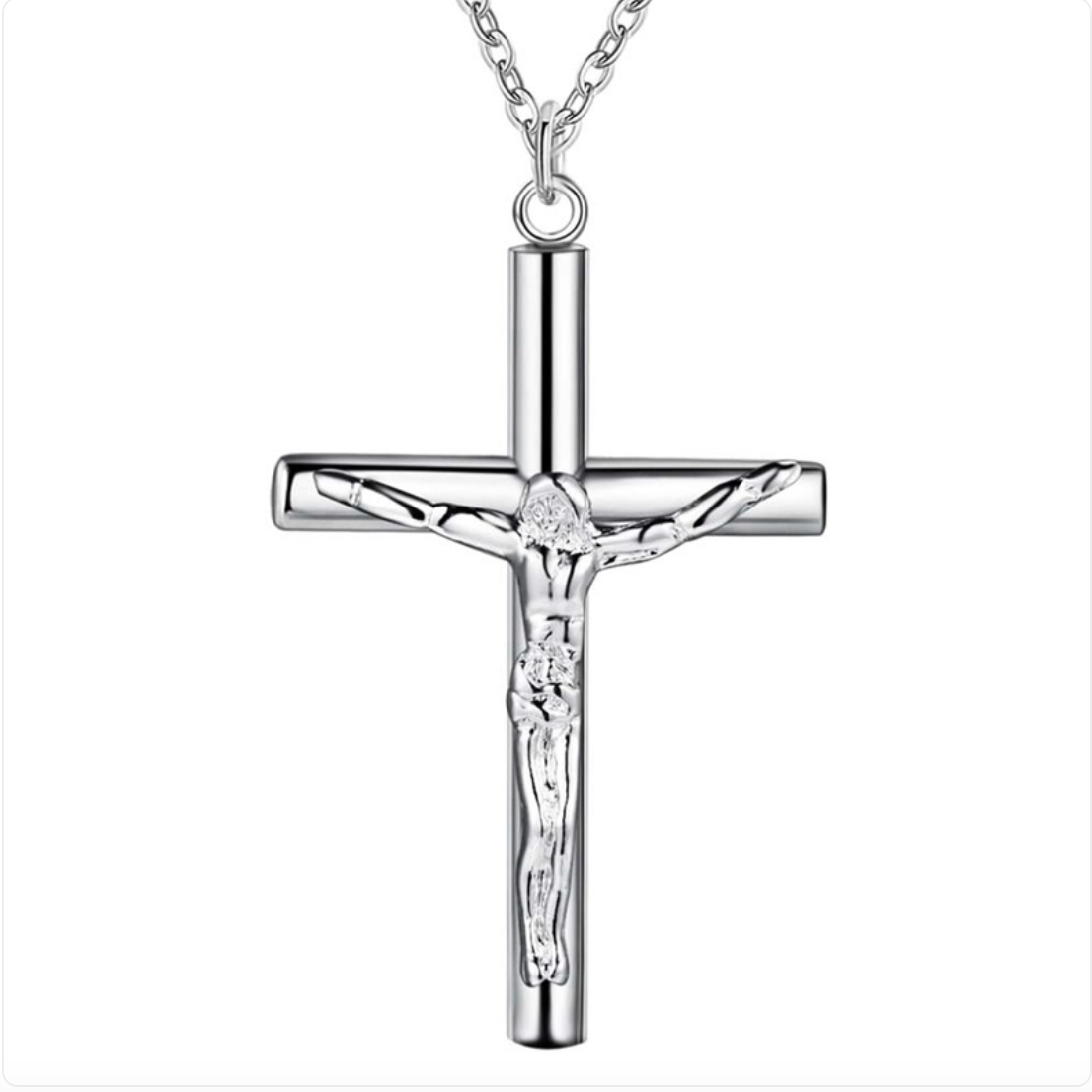 A polished silver crucifix pendant necklace featuring a detailed corpus of Jesus Christ on a cylindrical cross, suspended from a matching silver chain against a plain white background.