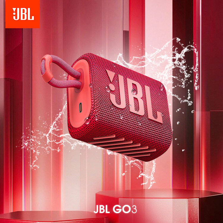 Red JBL Go 3 Bluetooth speaker close-up. Features waterproof IP67 fabric and integrated loop. Best red ultra-portable speaker.